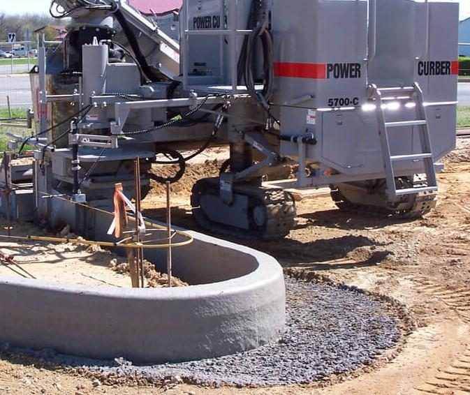 Power Curber 5700-C machine extruding concrete curb