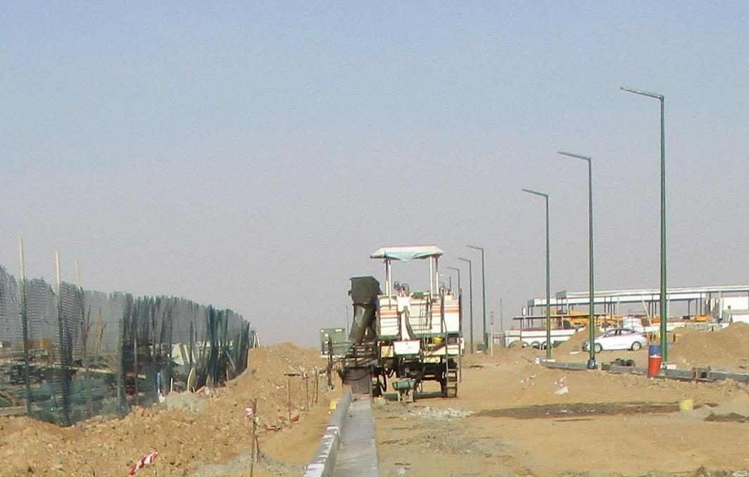 Road paving and street lighting installation in progress